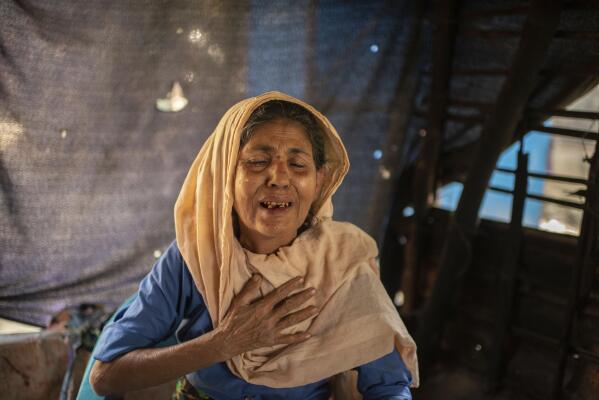 Momina Begum speaks about losing her son, Muhammed Ibrahim, his wife, Kurshida Begum, and their two children, Muhammed Shahin and Muhammed Fahim, during an interview at the Nayapara refugee camp in Teknaf, part of the Cox's Bazar district of Bangladesh, on March 8, 2023. Momina feels she is burning in a fire or sinking under water. “It would be better to kill us by poison instead of taking away my family,” she says. (AP Photo/Mahmud Hossain Opu)