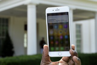 
              The first test of the national wireless emergency system by the Federal Emergency Management Agency is shown on a cellular phone at the White House in Washington, Wednesday, Oct. 3, ...