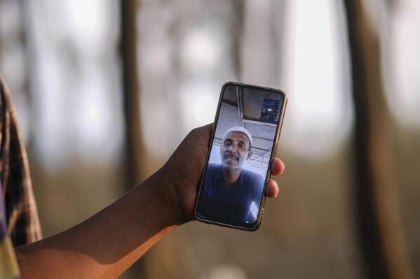 Rohingya refugee Kafayet Ullah in Sri Lanka participates in an interview in a video call, seen in the Cox’s Bazar district of Bangladesh, on March 6, 2023. Ullah's niece and nephew were aboard Jamal Hussein's vessel, which looked old and overloaded, the passengers packed in tight like animals. “I saw with my own eyes,” Kafayet says. “The boat sank.” (AP Photo/Mahmud Hossain Opu)