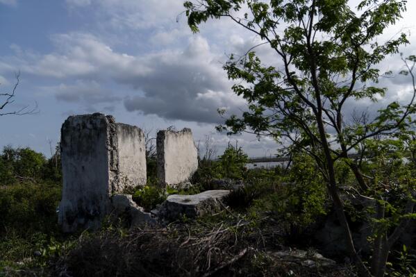 The walls of an old church made in part by burning down conch shells into a mortar, stand in McLean's Town, Grand Bahama Island, Bahamas, Monday, Dec. 5, 2022. Few countries are as synonymous with a seafood as the Bahamas are with conch. The shellfish appears prominently at the top of the national coat of arms and conch is widely recognized as the national dish. Symbols of the shellfish are everywhere. Conch shells serve as artwork, paperweights, bowls, musical instruments, Christmas ornaments and more. (AP Photo/David Goldman)