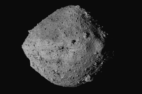 This undated image made available by NASA shows the asteroid Bennu from the OSIRIS-REx spacecraft. After almost two years circling the ancient asteroid, OSIRIS-REx will attempt to descend to the treacherous, boulder-packed surface and snatch a handful of rubble on Tuesday, Oct. 20, 2020. (NASA/Goddard/University of Arizona/CSA/York/MDA via AP)