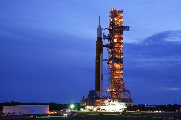 FILE - The NASA moon rocket slated for the Artemis mission to the moon rolls back to the Vehicle Assembly Building at the Kennedy Space Center Tuesday, Sept. 27, 2022, in Cape Canaveral, Fla. On Tuesday, Nov. 8, 2022, NASA announced it is again postponing the launch of its new moon rocket because of a storm threatening the Florida coast. NASA was aiming for a launch attempt this weekend _ just after midnight on Sunday. (AP Photo/John Raoux, File)