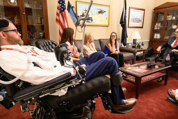 In this photo provided by The ALS Association, representatives from the group meet with former Tennessee Congressman Phil Roe, right, in his offices on Capitol Hill in Washington on March 14, 2022. The ALS Association and other patient groups have been lobbying federal officials for over a year seeking access to an experimental drug from Amylyx Pharmaceuticals. The Food and Drug Administration will soon meet to review the drug’s safety and effectiveness. (Kevin Allen/The ALS Association via AP)