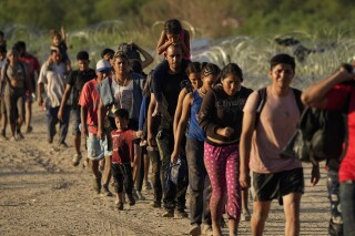 Migrants who crossed the Rio Grande and entered the U.S. from Mexico are moved for processing by U.S. Customs and Border Protection, Saturday, Sept. 23, 2023, in Eagle Pass, Texas. People who enter the U.S. illegally do not receive $2,200 each month from the federal government, as some online have claimed. (AP Photo/Eric Gay)