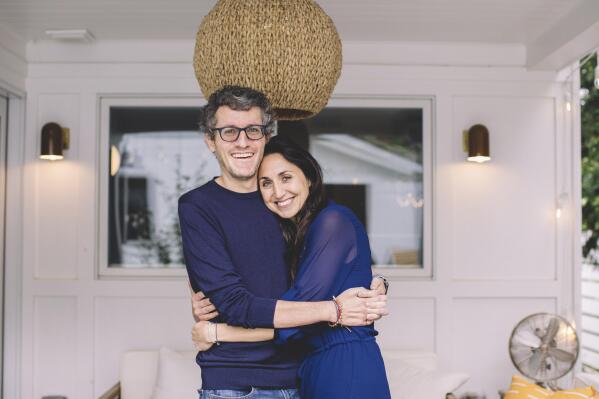 This photo provided by ALS patient Brian Wallach shows him and his wife, Sandra Abrevaya, at their home in Chicago on May 2021. Wallach, who formed I AM ALS with Abrevaya after being diagnosed with ALS in 2017, spent years working on legislation with congressional staffers, researchers and patients which passed the House last December in a landslide 423-3 vote. (Julie Dietz via AP)